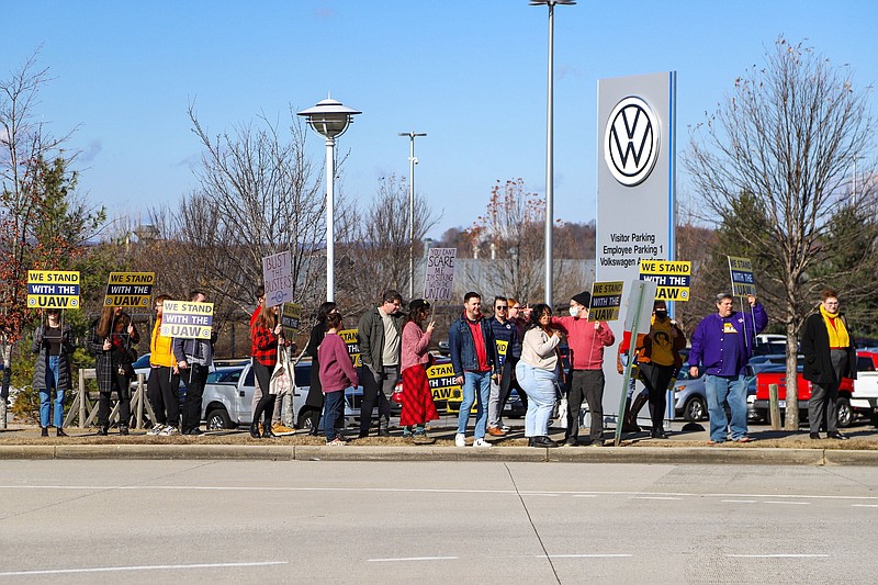 Staff photo by Olivia Ross / Pro-union supporters walk away from the Volkswagen Chattanooga plant with their signs in December. UAW President Shawn Fain visited the facility with members of Chattanoogans in Action for Love, Equality and Benevolence.