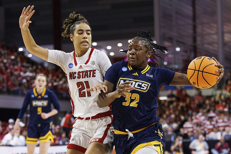 AP photo by Ben McKeown / UTC's Raven Thompson (32) drives past N.C. State's Madison Hayes during an NCAA tournament first-round game Saturday in Raleigh, N.C.