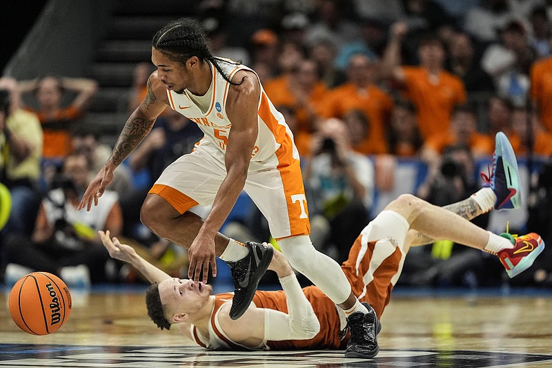 AP photo by Mike Stewart / Tennessee's Zakai Zeigler steals the ball as Texas guard Chendall Weaver looks on during an NCAA tournament second-round game Saturday night in Charlotte, N.C. No. 2 seed Tennessee beat the seventh-seeded Longhorns 62-58, with the win sending the Vols to the Sweet 16 for the second straight season.