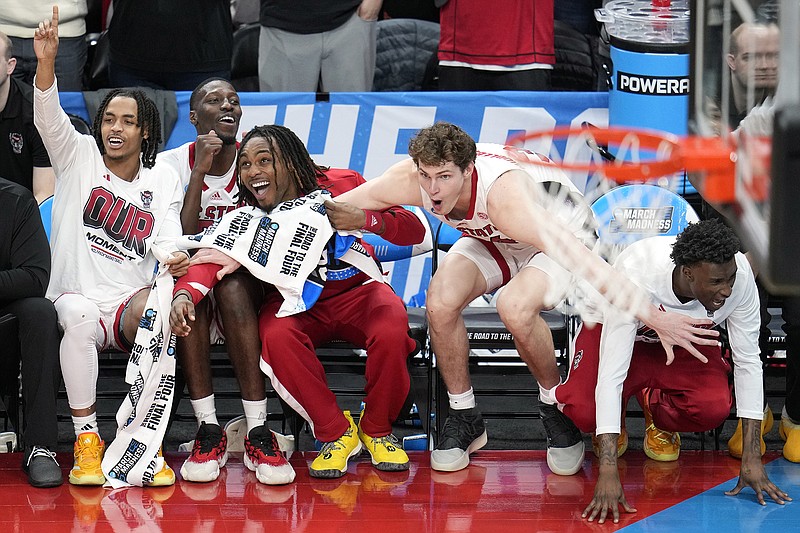 AP photo by Gene J. Puskar / N.C. State players celebrates on the sideline in the final minute of the Wolfpack's 79-73 overtime win against Oakland in the second round of the NCAA tournament Saturday in Pittsburgh.