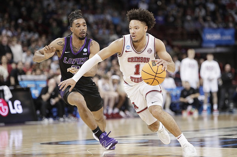 AP photo by Young Kwak / Alabama's Mark Sears dribbles past Grand Canyon guard Collin Moore during an NCAA tournament second-round game Sunday in Spokane, Wash.