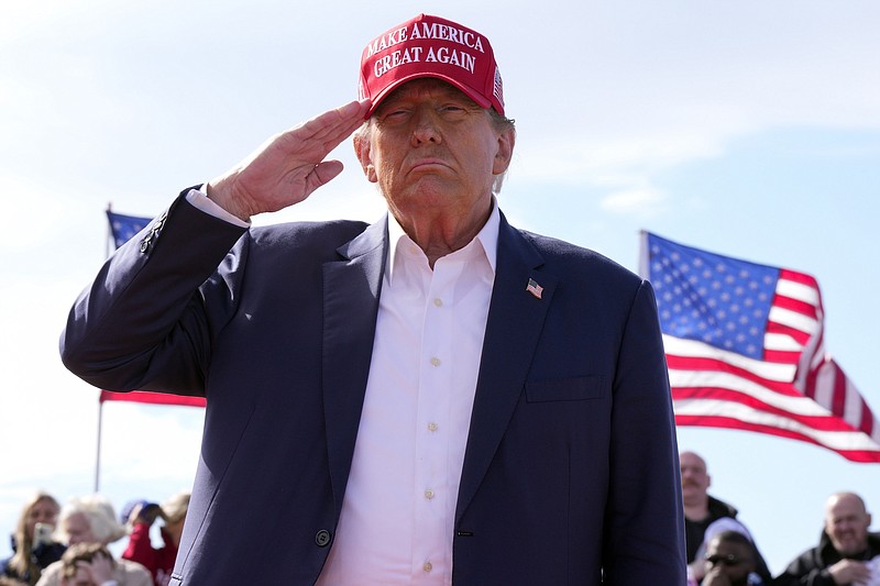 Photo/Jeff Dean/The Associated Press / Republican presidential candidate former President Donald Trump salutes at a campaign rally on March 16, 2024, in Vandalia, Ohio.