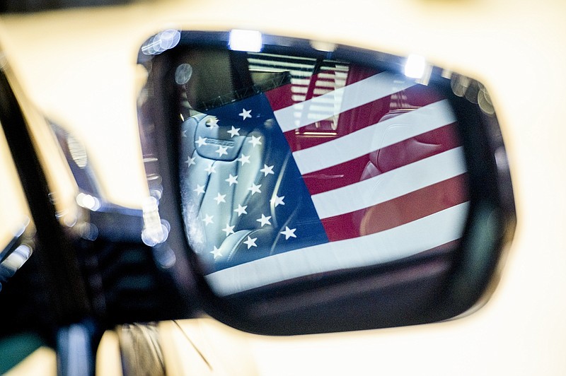 Photo/Pete Kiehart/The New York Times / An American flag is reflected in a side view mirror of a new Jeep SUV with plug-in hybrid technology during an EPA event in Washington, on March 20, 2024. The Biden camp elevated Trump's "bloodbath" rant against its car-industry policies and then set up the ripest possible policy target for his next round of attacks, NYT columnist Ross Douthat writes.