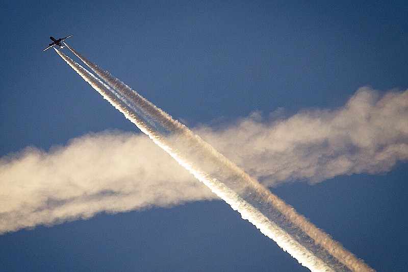 An aircraft crosses the vapor trails of another plane over Frankfurt, Germany, on April 19, 2018. A Tennessee state senator relates a bill to chemtrails, a conspiracy theory related to the lines of vapor coming from jet planes. (AP Photo/Michael Probst, File)
