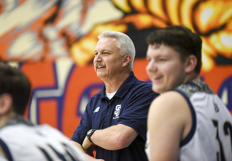 Staff photo / Soddy Daisy boys' basketball coach Bill Eller smiles as a 3-point shot goes in at the buzzer to the end the first half of a win against Sequatchie County in the Chatt-Town Classic in December 2019.