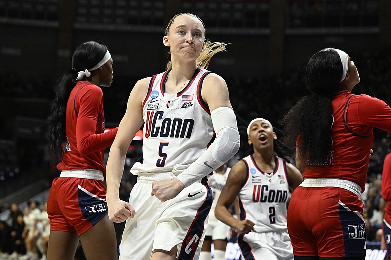AP photo by Jessica Hill / Connecticut guard Paige Bueckers flexes after making a basket while getting fouled during an NCAA tournament second-round game against Jackson State on Saturday in Storrs, Conn.