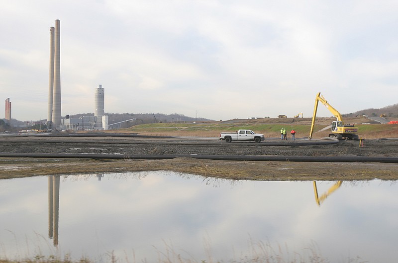 Staff Photo / The TVA Kingston Fossil Plant is reflected in a new storage pond, rebuilt after a Dec. 22, 2008, coal ash spill, which blanketed more than 300 acres in Harriman, Tenn. TVA announced Tuesday it would end coal use at the plant by 2027, switching to natural gas and solar power.