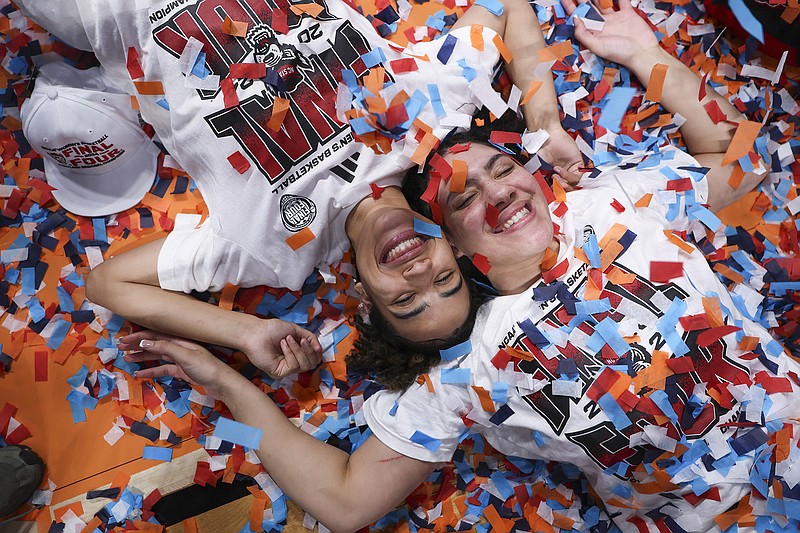 AP photo by Howard Lao / N.C. State guard Madison Hayes, left, and forward Mimi Collins celebrate after the Wolfpack's NCAA tournament Elite Eight victory against Texas on Sunday in Portland, Ore.