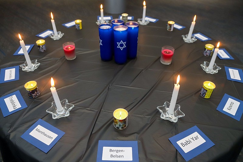 Staff file photo/Olivia Ross / Lit candles at the Jewish Cultural Center in Chattanooga recognize the concentration camps that existed during the Holocaust during an observance in April 2022. Holocaust education is critical, especially now with re-emergence of Holocaust deniers, writes columnist Deborah Levine.