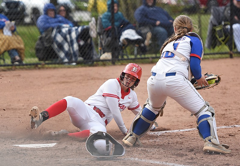 Staff photo by Matt Hamilton / Baylor's Holly Merritt slides in safe at home as Cleveland catcher Lily Mason can't make the tag in time during Thursday's TSSAA softball matchup in Chattanooga.