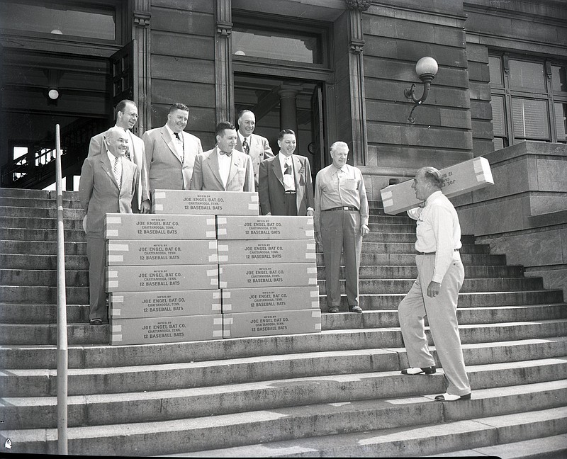 Chattanooga News-Free Press archive photo via ChattanoogaHistory.com / Chattanooga Lookouts President Joe Engel, far right, is shown delivering bats to Chattanooga city officials in 1952. Engel and his business partners had started Joe Engel Bat Co. on Riverside Drive to make laminated, multipiece bats that were considered more durable than traditional one-piece bats.