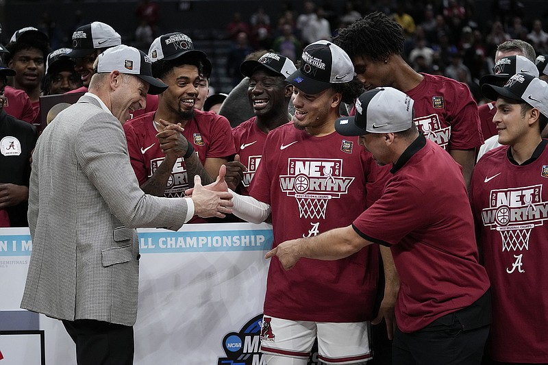 Alabama head coach Nate Oats, left, shakes hands with guard Mark Sears after a win over against Clemson in an Elite 8 college basketball game in the NCAA tournament Saturday, March 30, 2024, in Los Angeles. (AP Photo/Ashley Landis)