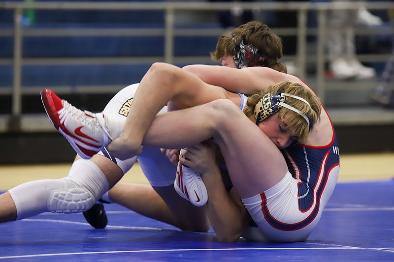 Staff photo by Olivia Ross / Chattanooga Christian School's Ryder Smith (left) goes up against Heritage's Evan Wingrove at the McCallie Wrestling Innovational on Saturday, December 9, 2023.