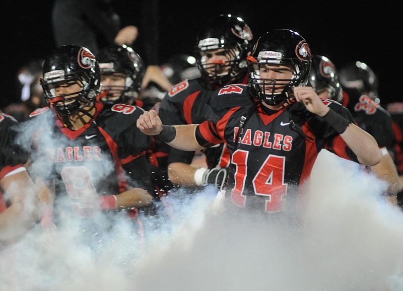 Staff file photo / Signal Mountain quarterback Hogan Whitmire and other players run through smoke while entering the field before a game in 2010. The Eagles set a record for points scored that season that will be tough to match.