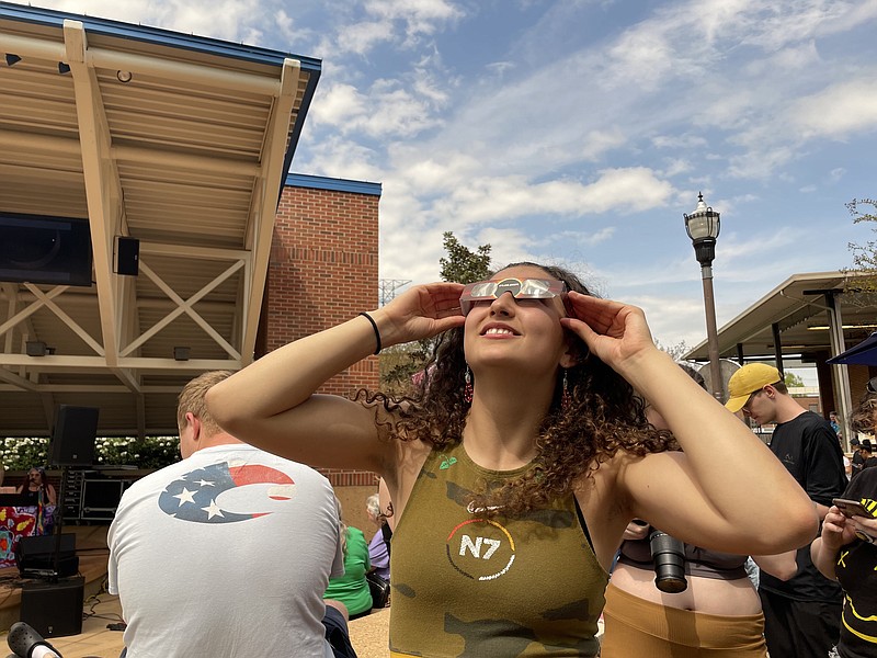 Staff Photo by Shannon Coan / Chattanooga State student Aiyana Loher looks at the partial solar eclipse from the Chattanooga State Community College campus Monday.