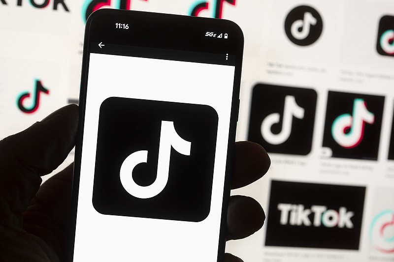 AP File Photo/Michael Dwyer / The TikTok logo is seen on a mobile phone in front of a computer screen which displays the TikTok home screen, Oct. 14, 2022, in Boston.