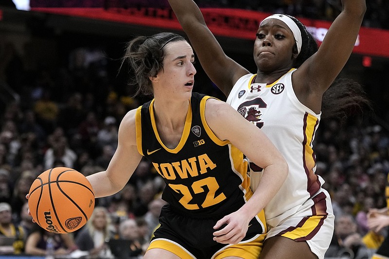 Photo/Morry Gash/The Associated Press / Iowa guard Caitlin Clark (22) drives around South Carolina guard Raven Johnson (25) during the second half of the Final Four college basketball championship game in the women's NCAA Tournament on April 7, 2024, in Cleveland.