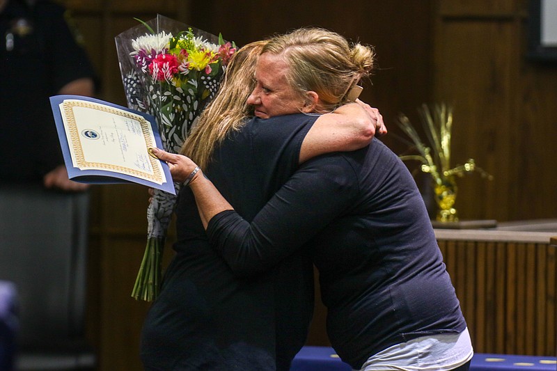 Staff photo by Olivia Ross / Amy Piercy, left, hugs Paige Robinette, resident manager at The Launch Pad, during Piercy's graduation from the Hamilton County Drug Recovery Court program on Monday.