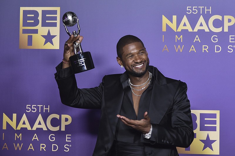 Usher poses in the press room during the 55th NAACP Image Awards on March 16 at The Shrine Auditorium in Los Angeles. (Photo by Richard Shotwell/Invision/AP)