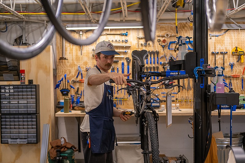 Contributed Photo / Mitchell Connell, executive director of Two Bikes, works on a bike. Two Bikes will open its new location in Chattanooga on Saturday.