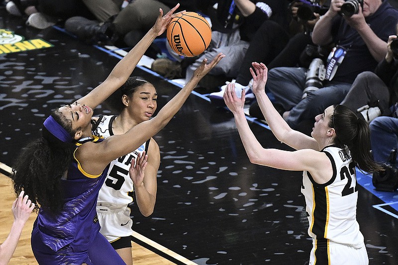 AP photo by Hans Pennink / LSU forward Angel Reese, left, battles for a rebound with Iowa guard Caitlin Clark, right, during an NCAA tournament Elite Eight game on April 1 in Albany, N.Y.
