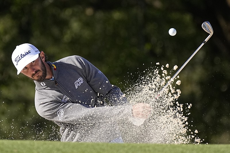 AP photo by George Walker IV / Max Homa hits from a bunker on the 18th hole at Augusta National Golf Club on Friday, completing his first round after Thursday's play was suspended by darkness after earlier being delayed by weather.