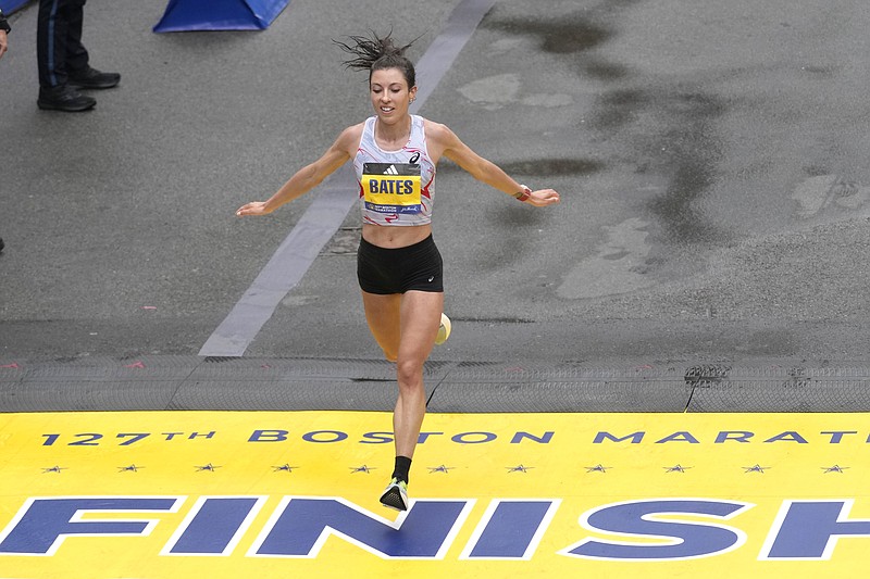 AP photo by Charles Krupa / Emma Bates crosses the finish line of the Boston Marathon on April 17, 2023. Bates is hoping to improve on last year's fifth-place finish when she lines up for the 26.2-mile race again Monday.
