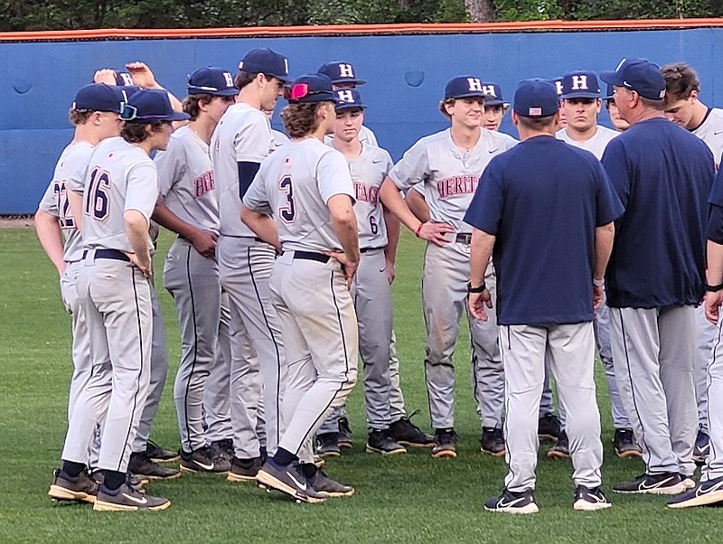 Staff photo by Lindsey Young / Heritage baseball coach David Dinger, right, talks with his team following Monday night's 8-4 win at Northwest Whitfield. With the win, the Generals clinched the Region 7-AAAA championship.