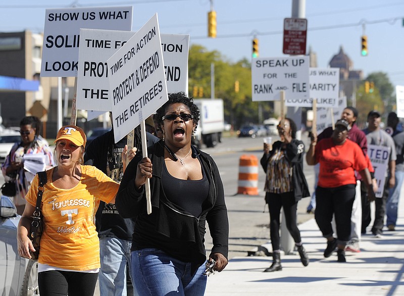 Protestors picket in 2015 outside UAW Solidarity House in Detroit against the provisions of a tentative contract agreement reached with Fiat Chrysler. (David Coates/The Detroit News via AP)