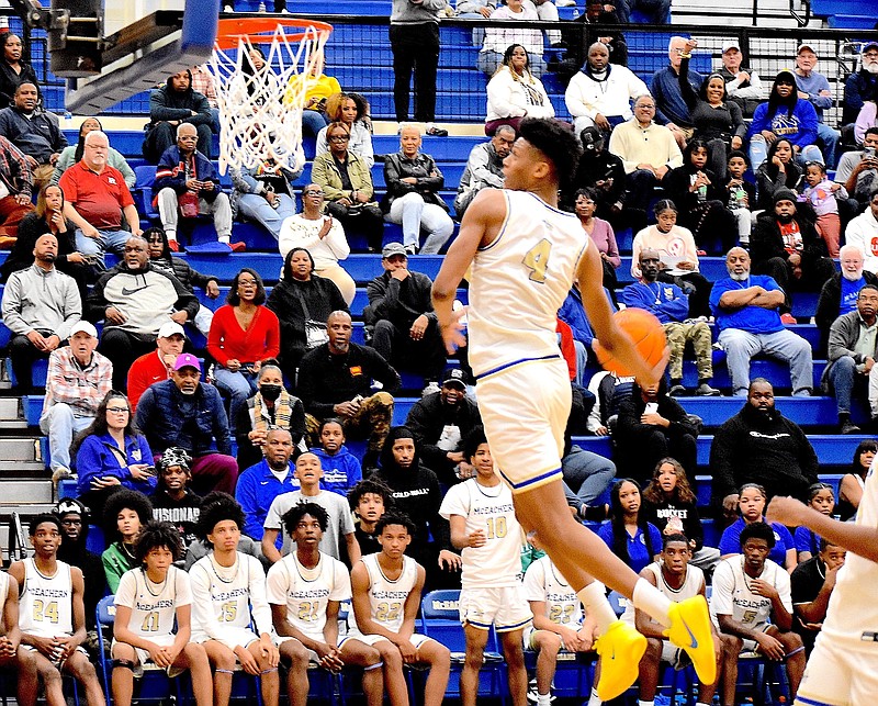 Staff photo by Patrick MacCoon / McEachern High School star Ace Bailey goes up for a windmill dunk in a GHSA postseason game.