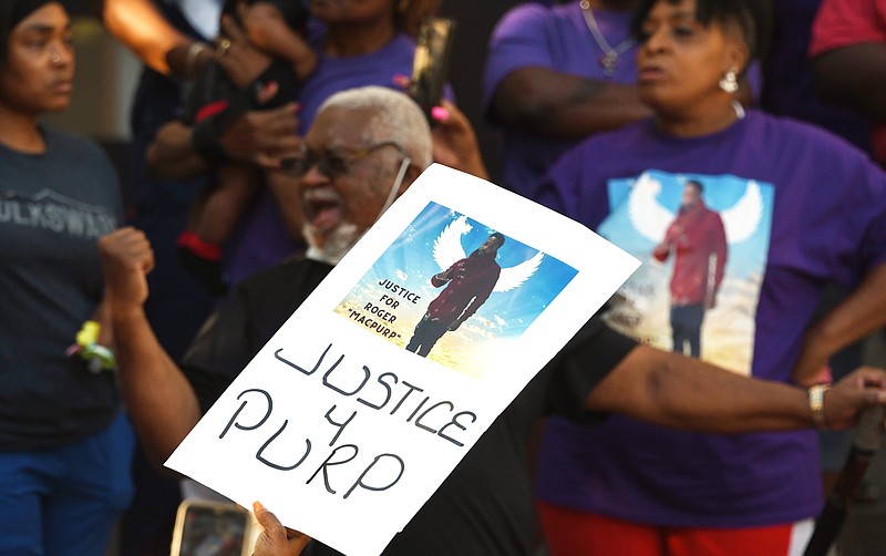 Staff Photo by Robin Rudd / A sign calling for justice for Roger Heard Jr. is held above the crowd at Chattanooga City Hall. The three Chattanooga police officers involved in the shooting that killed Heard will not be charged criminally, the District Attorney's Office said.