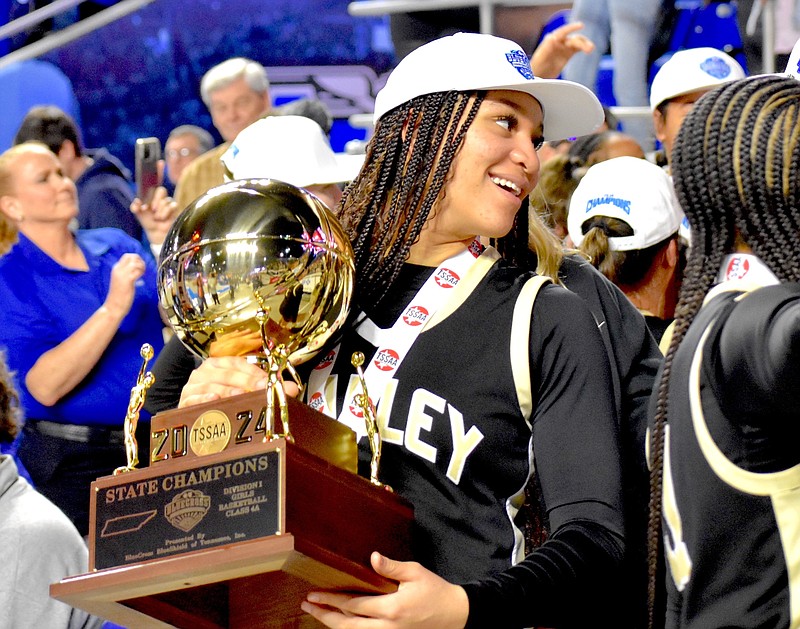 Staff photo by Patrick MacCoon / Bradley Central basketball standout Kimora Fields holds her team's state championship trophy after the Bearettes won the TSSAA Class 4A title game on March 9 in Murfreesboro.