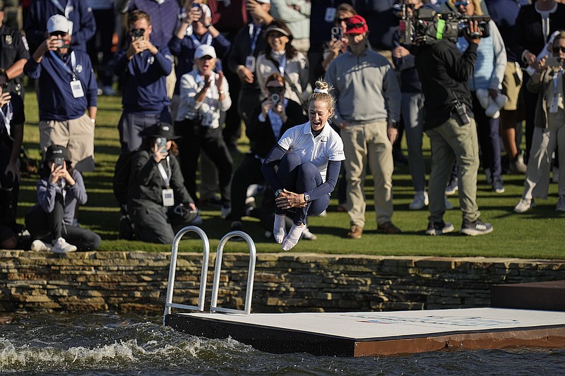 AP photo by Eric Gay / Nelly Korda jumps into the lake to celebrate winning the LPGA Tour's Chevron Championship, her second major championship, on Sunday at The Club at Carlton Woods in The Woodlands, Texas.