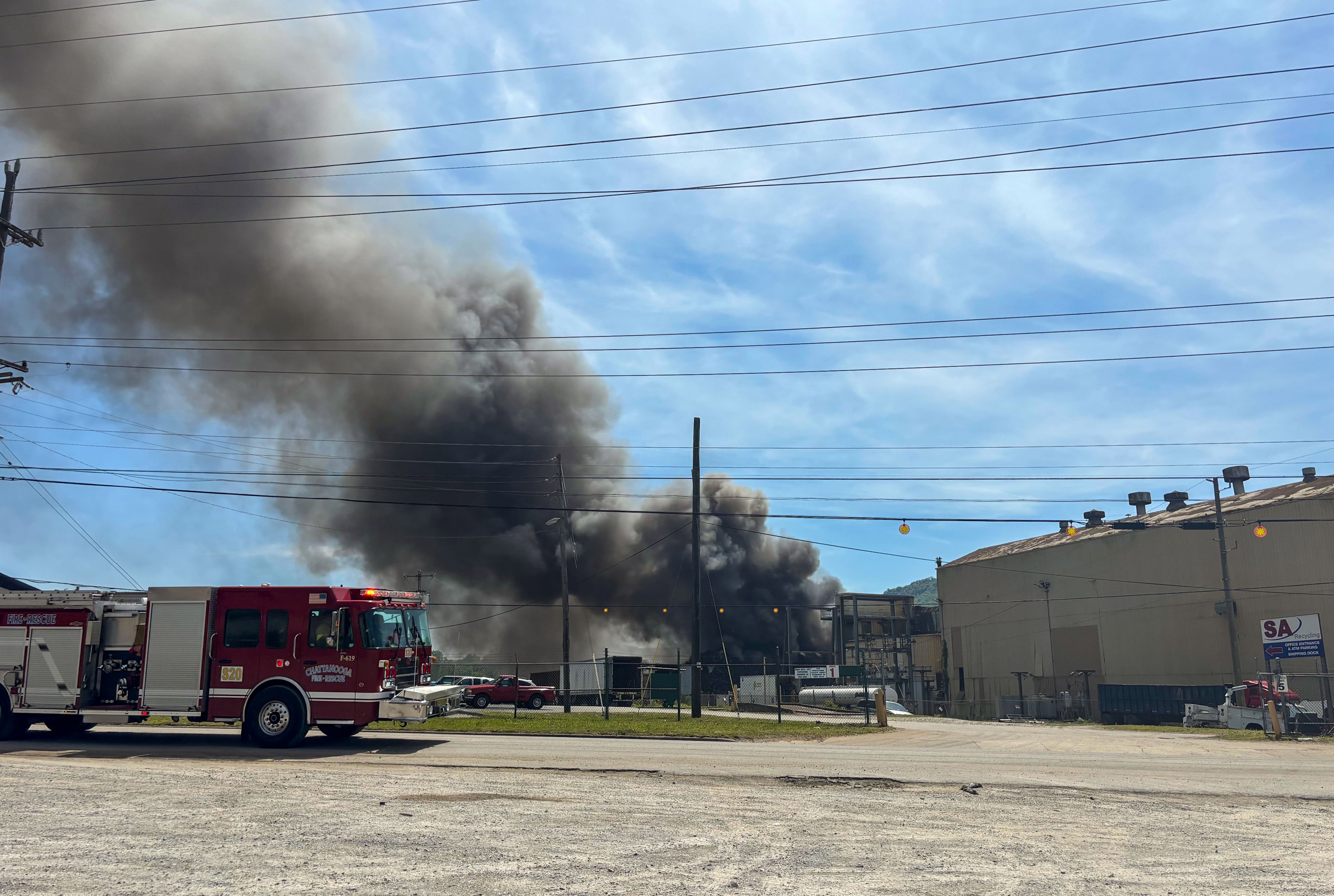 Staff photo by Olivia Ross / Clouds of smoke from a fire near 980 West 19th Street are seen on Tuesday. Piles of scrap metal burned at the recycling facility, according to the Chattanooga Fire Department.