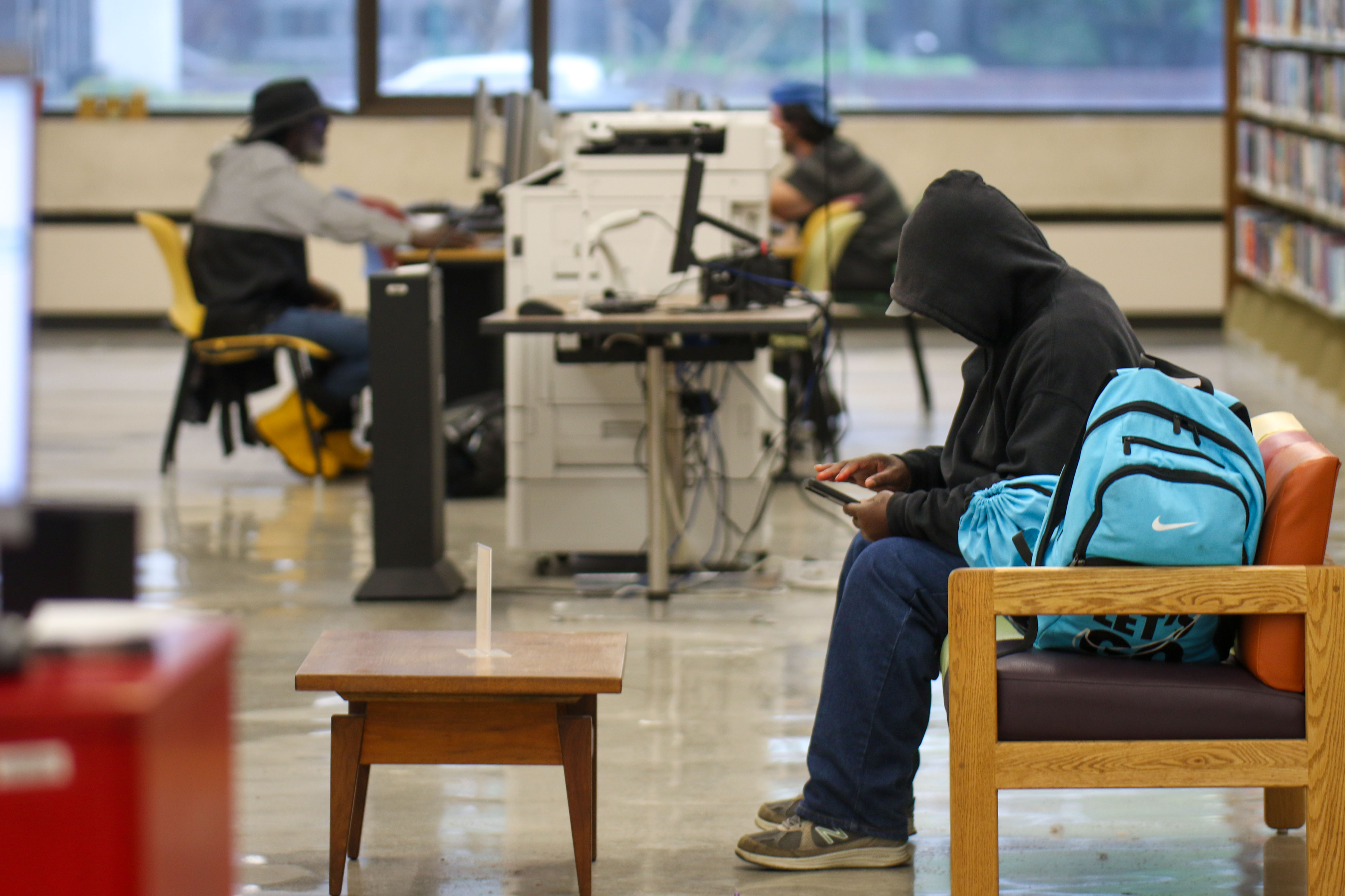Staff photo by Olivia Ross / A visitor sits in the Chattanooga Public Library downtown April 10.
