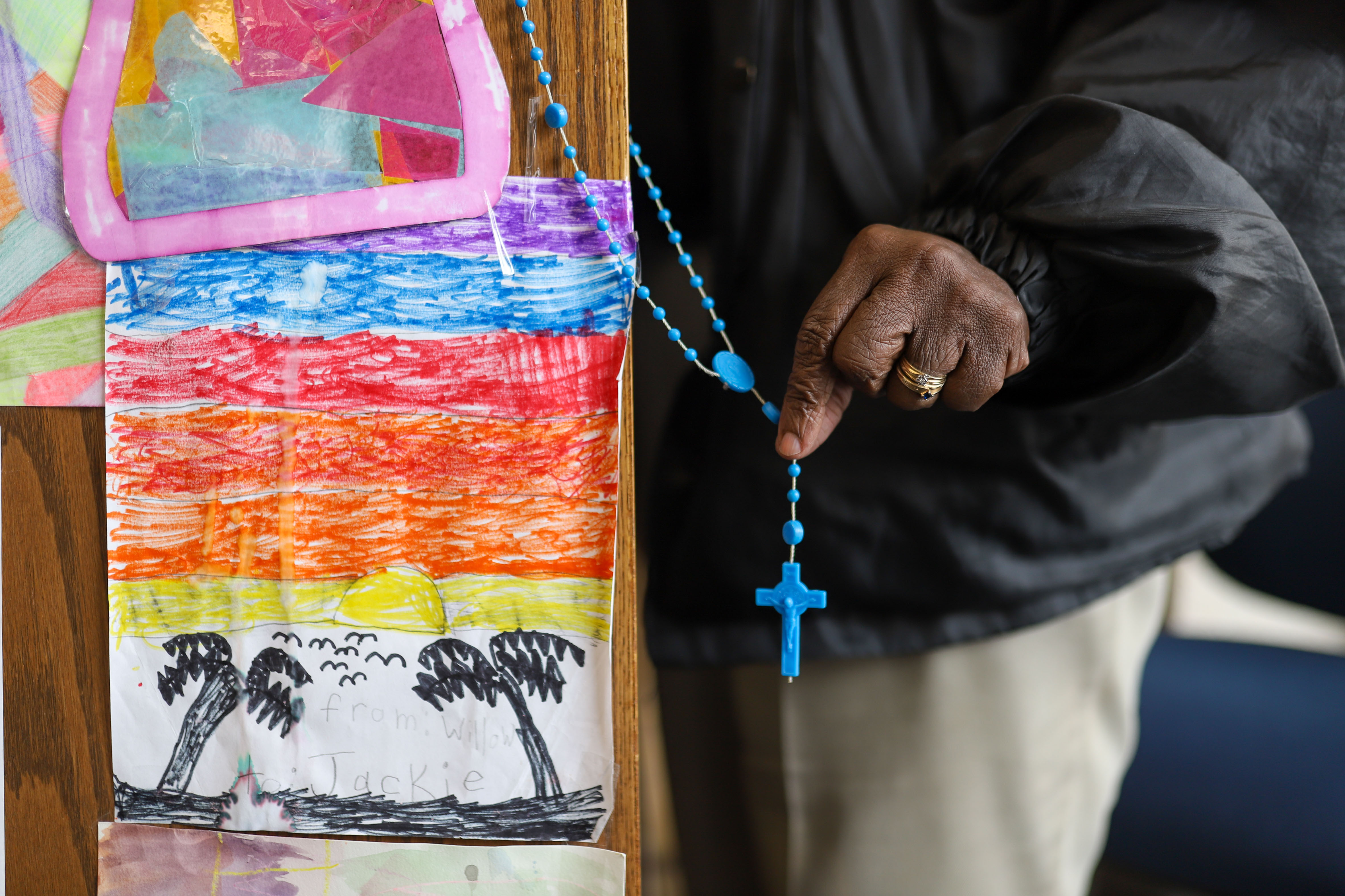 Staff photo by Olivia Ross / Security guard Jackie Strickland holds up a rosary Tuesday given to her by a library guest, seen at the Chattanooga Public Library downtown.