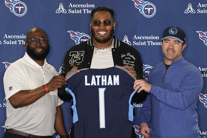 AP photo by George Walker IV / Former Alabama offensive lineman JC Latham, center, poses with Tennessee Titans general manager Ran Carthon, left, and head coach Brian Callahan at a news conference Friday in Nashville. The Titans selected Latham with the No. 7 pick of the first round of the NFL draft Thursday night in Detroit.