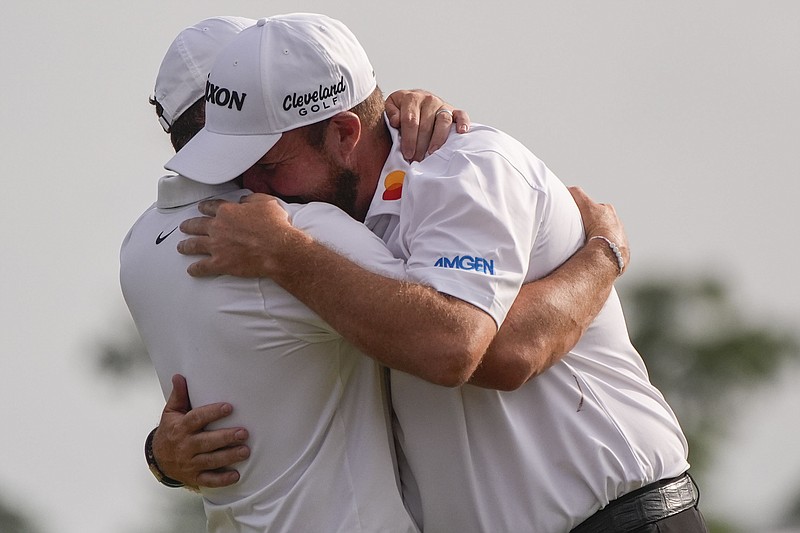 AP photo by Gerald Herbert / Shane Lowry, right, embraces teammate Rory McIlroy after they won the PGA Tour's Zurich Classic of New Orleans in a playoff Sunday at TPC Louisiana in Avondale, La.