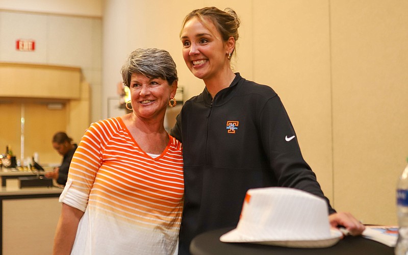 Staff photo by Olivia Ross / New Tennessee women's basketball coach Kim Caldwell, right, visits with Lady Vols supporter Teresa Ward during the Big Orange Caravan's visit to Chattanooga on Wednesday night.