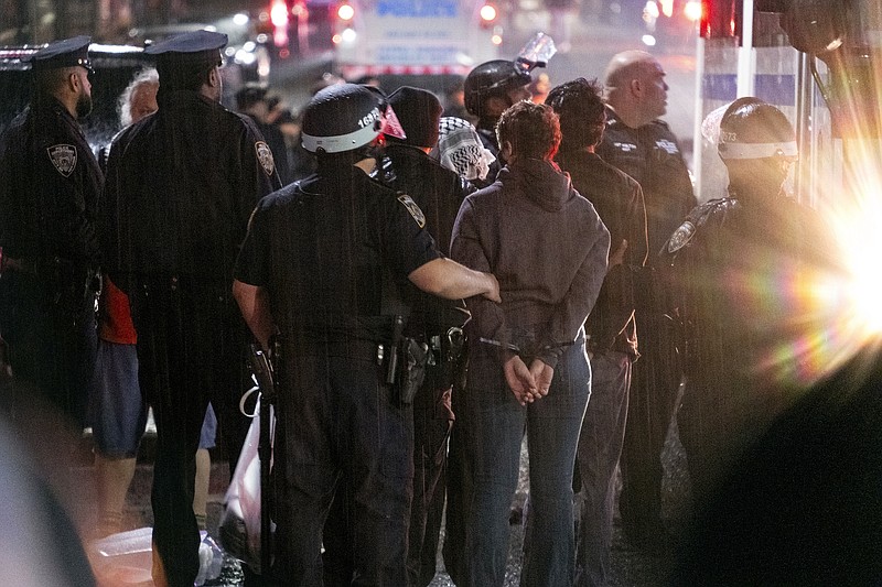 File photo/Craig Ruttle/The Associated Press / New York City police officers take people into custody near the Columbia University campus in New York on Tuesday, April 30, 2024, after a building taken over by protesters earlier in the day was cleared, along with a tent encampment.