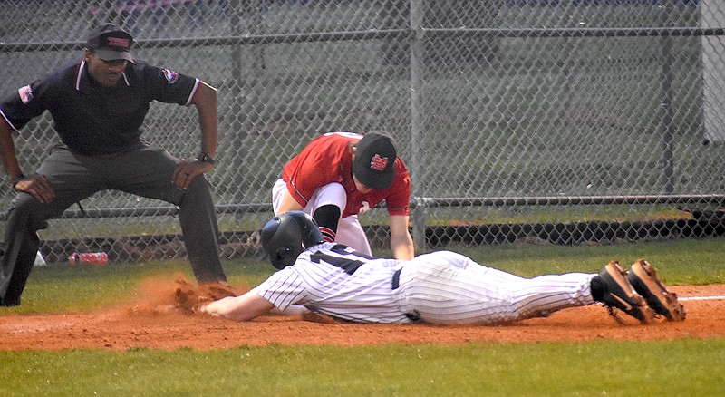 Staff photo by Patrick MacCoon / Soddy Daisy's Keith Scoggins slides safely into third on his bases-clearing triple in Friday's District 6-3A title game against Signal Mountain at Red Bank High School. Inclement weather kept the game from being completed Friday or Saturday, and the teams are set to return to the field Sunday afternoon.