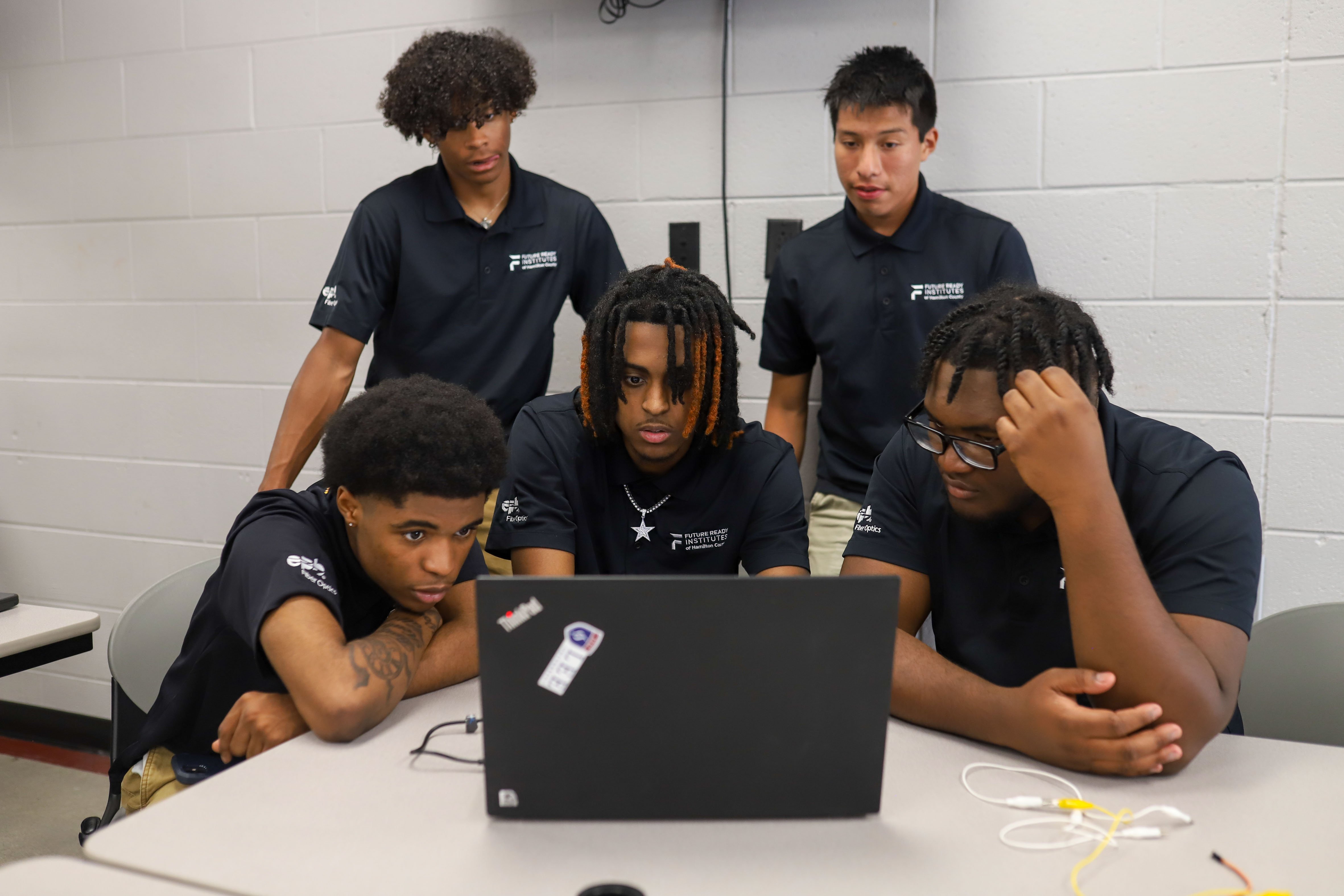 Staff photo by Olivia Ross / From left, Maurice Ellison, Travon Adams, Qwanelle Lowe, Adrian Vazquez and Cameron Tucker play different tunes through the program they created at Tyner Academy. EPB Future Ready Institute of Technology and Networking students demonstrated their creations during Tyner's World Quantum Day showcase on Tuesday.