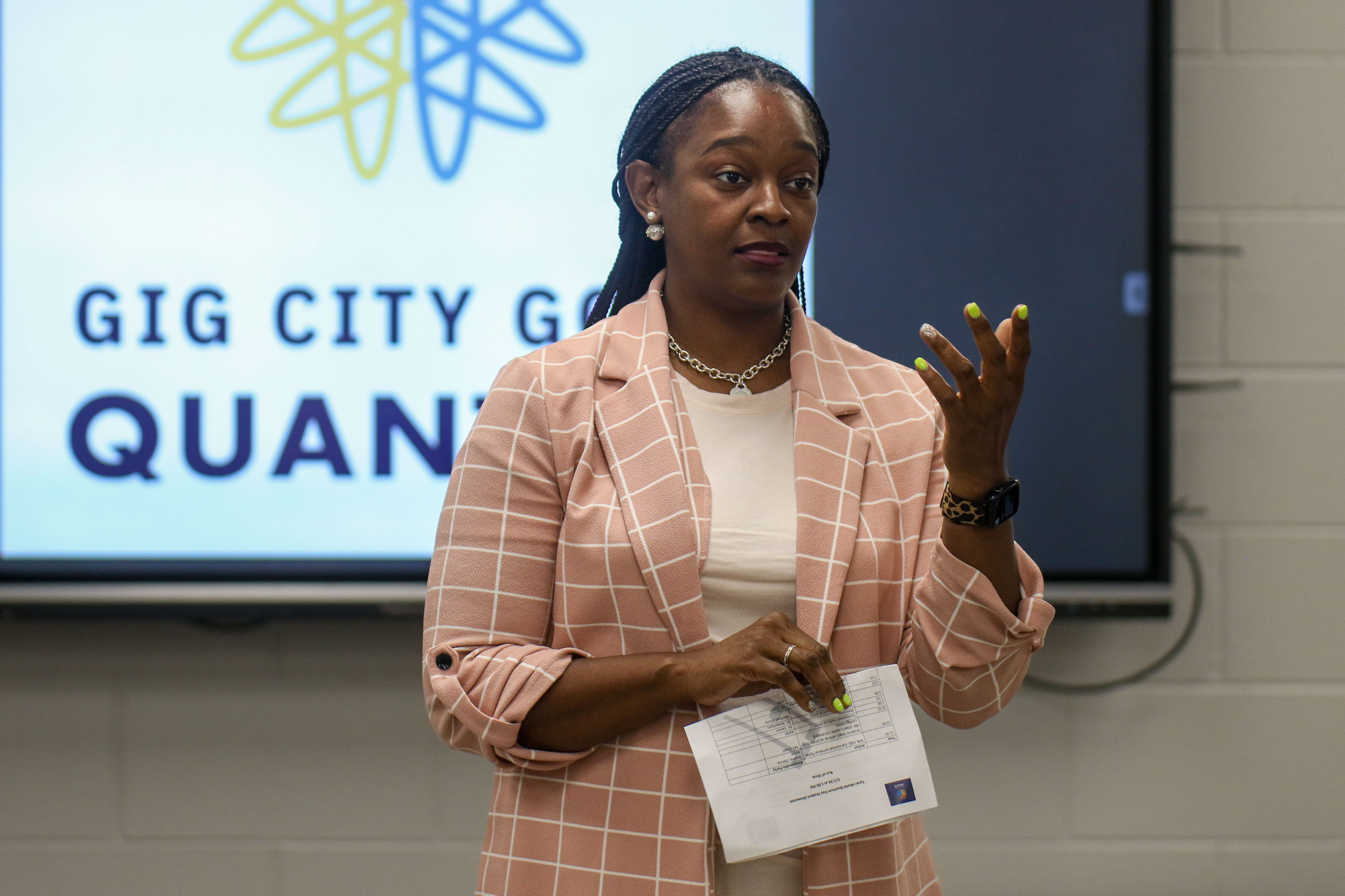 Staff photo by Olivia Ross / Tyner Principal Tiffany Earvin speaks to the room. EPB Future Ready Institute of Technology and Networking students demonstrated their creations during Tyner's World Quantum Day showcase on Tuesday.