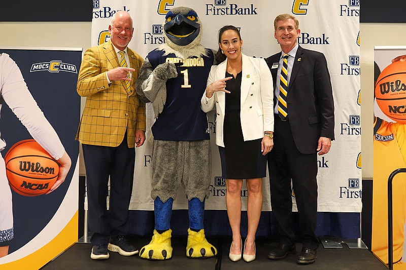 Staff photo by Olivia Ross / From left, UTC athletic director Mark Wharton, Mocs mascot Scrappy, women's basketball coach Deandra Schirmer and Chancellor Steve Angle pose on April 5 at Lupton Hall. Schirmer was introduced as the newest coach of the Mocs that day.