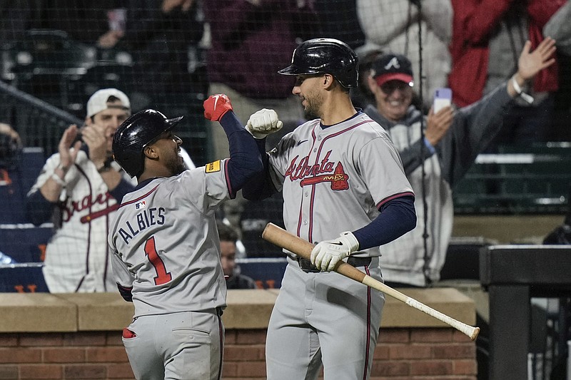 AP photo by Frank Franklin II / Atlanta Braves second baseman Ozzie Albies, left, celebrates with first baseman Matt Olson after hitting a home run during the third inning of Friday's win against the host New York Mets.