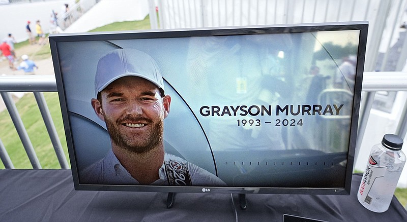 AP photo by LM Otero / A television at the broadcast tent shows a photo of PGA Tour player Grayson Murray during the third round of the Charles Schwab Challenge at Colonial Country Club on Saturday in Fort Worth, Texas. Murray, a two-time winner on the tour, died Saturday morning at age 30, one day after he withdrew from the tournament.