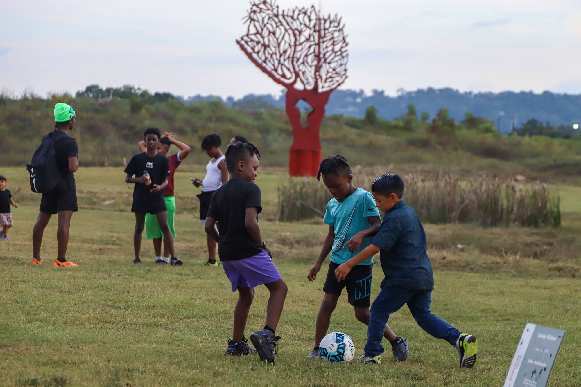 Staff photo by Olivia Ross / Children play with a soccer ball in September at the Sculpture Fields at Montague Park. The city has included $500,000 for the reimagined park in its proposed budget.
