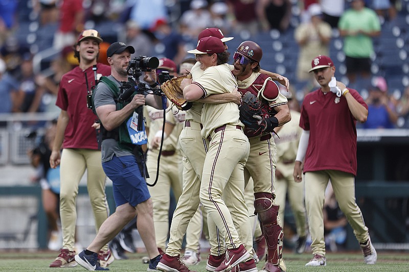 Florida State pitcher Connor Hults (15) is mobbed by teammates after defeating North Carolina by a score of 9-5 during an NCAA College World Series baseball elimination game on Tuesday, June 18, 2024, in Omaha, Neb. (AP Photo/Mike Buscher)