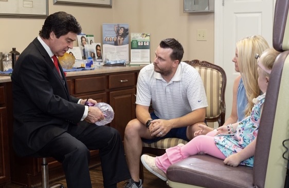 Contributed Photo / Dr. Larry Sargent speaks to the Wilson family about an upcoming facial reconstructive procedure for Beth, born with a rare genetic condition.