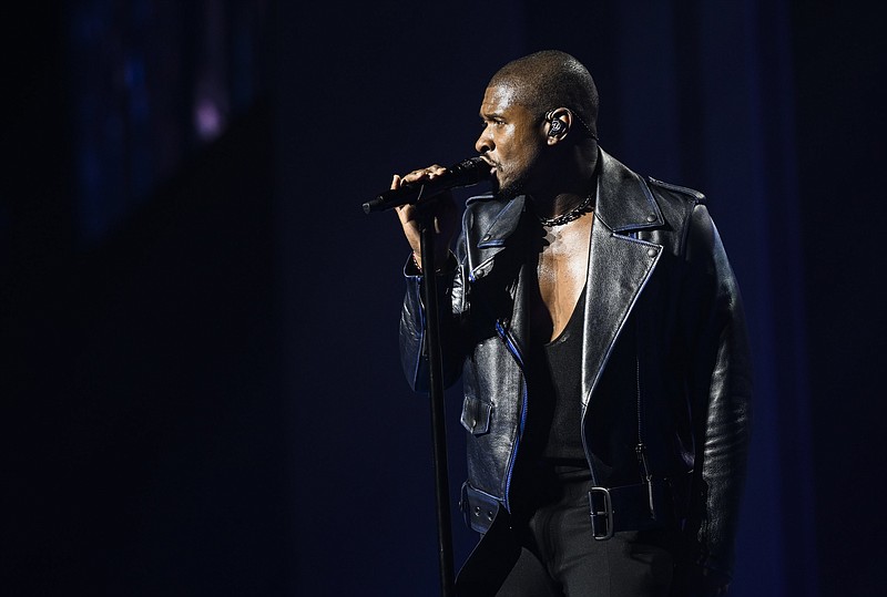 Usher performs June 7 during the annual Walmart employee celebration at Bud Walton Arena in Fayetteville, Ark. Walmart held its annual employee celebration with a celebrity host and guest artists, plus talks by company officers. / NWA Democrat-Gazette/Charlie Kaijo